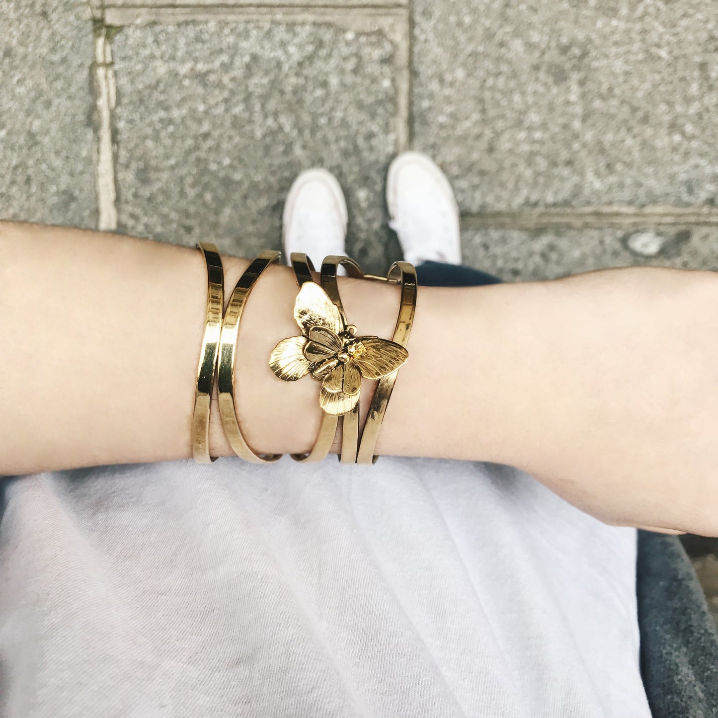 Wrist with gold butterfly bracelet