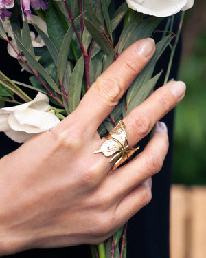 
                  
                    woman wearing gold butterfly ring
                  
                