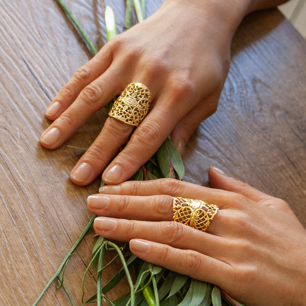 woman wearing gold lace style rings